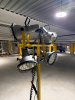GRAINGER PORTABLE FOUR-HEAD INDUSTRIAL WORK LIGHT / FLOODLIGHT TOWER WITH FOUR ADJUSTABLE METAL REFLECTOR LAMP HEADS, PROTECTIVE WIRE GUARDS, INDIVIDUAL HANDLES, COILED POWER CORDS, WHEELED STEEL BASE, VERTICAL SUPPORT MAST, AND LOWER EQUIPMENT PLATFORM. - 3