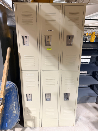 SIX-DOOR METAL LOCKER UNIT WITH TWO ROWS OF THREE FULL-SIZE VENTILATED COMPARTMENTS, RECESSED LOCK/HANDLE ASSEMBLIES, AND BEIGE FINISH.
