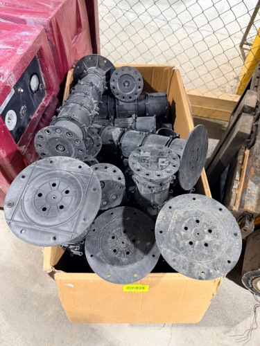LOT OF ADJUSTABLE PLASTIC PEDESTAL SUPPORTS WITH THREADED HEIGHT-ADJUSTMENT SECTIONS, WIDE CIRCULAR BASES, AND TOP SUPPORT PLATES.