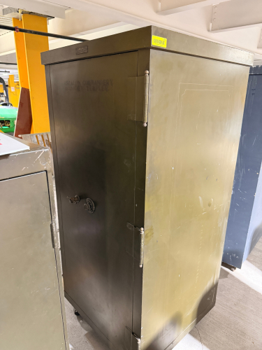 VINTAGE HEAVY-DUTY STEEL SAFE CABINET WITH SINGLE SWING DOOR, YALE MECHANICAL COMBINATION LOCK, T-HANDLE LOCKING MECHANISM, HEAVY EXTERNAL HINGES, AND MULTIPLE ADJUSTABLE INTERIOR STEEL SHELVES.