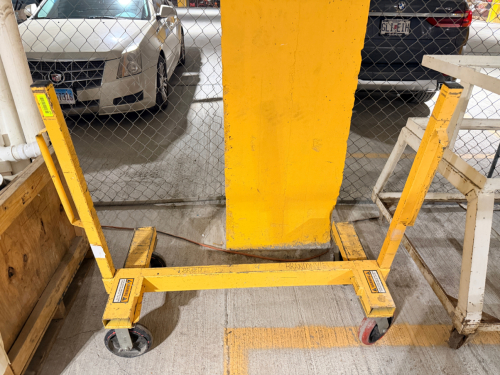 MOBILE MATERIAL HANDLING CART WITH HEAVY-DUTY WELDED STEEL FRAME, OPEN CENTER, TWIN UPRIGHT SUPPORTS, FORK-STYLE LOWER SUPPORT ARMS, AND FOUR SWIVEL CASTERS.