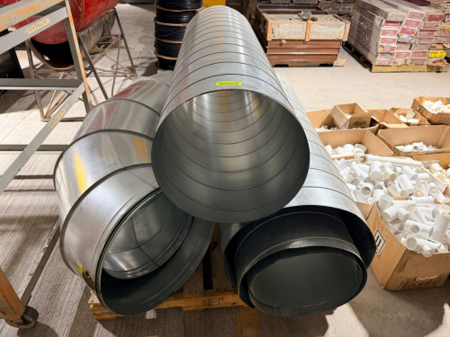 LOT OF GALVANIZED SPIRAL ROUND SHEET METAL HVAC DUCTWORK INCLUDING MULTIPLE LARGE-DIAMETER STRAIGHT DUCT SECTIONS AND ASSOCIATED ROUND FITTINGS. GALVANIZED STEEL CONSTRUCTION WITH SPIRAL-LOCK SEAMS.