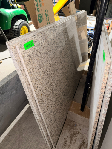 (4) PANEL GRANITE TUB SURROUND SET WITH POLISHED SPECKLED STONE SURFACES AND FINISHED EDGES. PANELS FEATURE A LIGHT GRAY, CREAM, BLACK, AND TAN NATURAL STONE PATTERN.