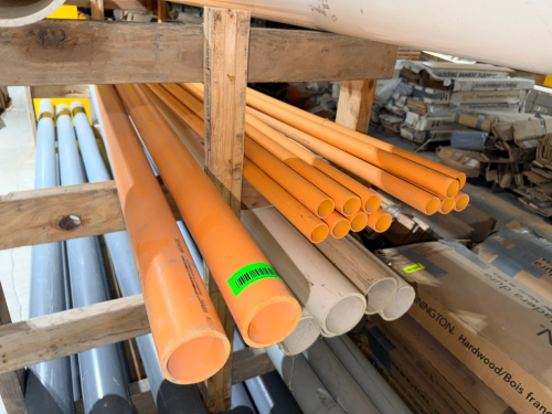 (1) LOT OF ORANGE 2" AND 1" HIGH-PRESSURE PVC PIPE AND ASSORTED PVC FITTINGS INCLUDING ELBOWS, TEES, COUPLINGS, REDUCERS, WYES, AND OTHER CONNECTION FITTINGS. INCLUDES MULTIPLE STRAIGHT PIPE SECTIONS AND TWO BOXES OF LOOSE FITTINGS AS PICTURED.