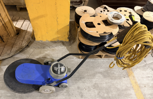 LIGHTNING 1500 COMMERCIAL FLOOR BURNISHER WITH BLUE MOLDED BODY, LARGE-DIAMETER PAD DRIVER, REAR TRANSPORT WHEELS, DUAL-HANDLE CONTROL ASSEMBLY, AND ATTACHED POWER CORD.