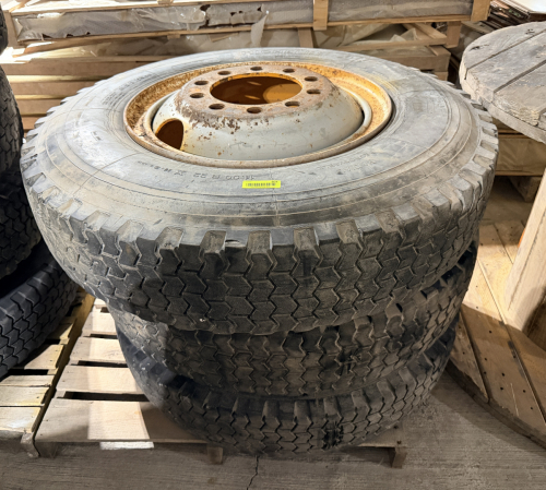 (3) MICHELIN 11.00R22 COMMERCIAL TRUCK TIRES WITH STEEL WHEELS. HEAVY-DUTY RADIAL TIRES MOUNTED ON MULTI-LUG STEEL DISC WHEELS. TIRES AND WHEELS ARE USED WITH VISIBLE DIRT, WEATHERING, SIDEWALL AGE CRACKING, AND HEAVY SURFACE RUST ON THE WHEELS.