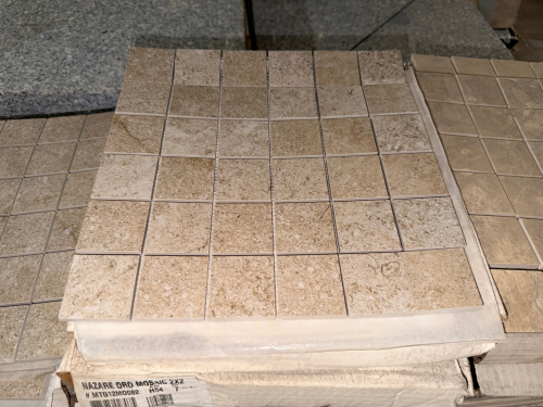 (22) BOXES NAZARE ORO 2" X 2" NATURAL STONE MOSAIC TILE SHEETS FEATURING BEIGE, TAN, AND CREAM COLORATION WITH NATURAL STONE VARIATION. TILES ARE MESH-MOUNTED IN SQUARE MOSAIC PATTERNS