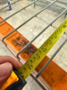 (2) 8' X 42" SECTIONS OF HEAVY-DUTY STEEL PALLET RACKING WITH ORANGE HORIZONTAL LOAD BEAMS, BLUE STEEL UPRIGHTS, AND WIRE DECKING. EACH SECTION INCLUDES TWO ELEVATED STORAGE LEVELS WITH WIRE DECK PANELS. - 4
