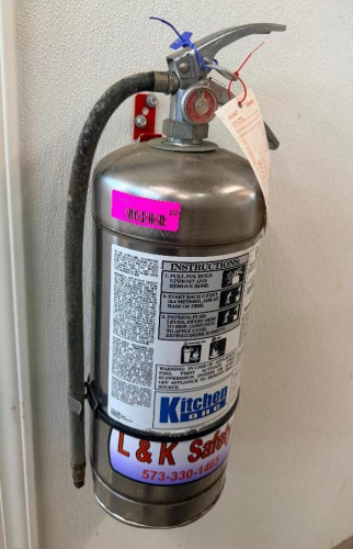 WET CHEMICAL FIRE EXTINGUISHER W/ WALL MOUNTED HOOK.