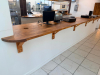 20' CUSTOM SOLID WOOD BUTCHER BLOCK COUNTERTOP SYSTEM WITH MULTIPLE CONNECTED SECTIONS, ROUNDED END SECTIONS, AND WALL-MOUNTED WOOD SUPPORT BRACKETS. COUNTERTOP FEATURES LAMINATED SOLID WOOD CONSTRUCTION WITH STAINED AND SEALED FINISH. INCLUDES MATCHING D