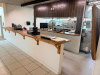 20' CUSTOM SOLID WOOD BUTCHER BLOCK COUNTERTOP SYSTEM WITH MULTIPLE CONNECTED SECTIONS, ROUNDED END SECTIONS, AND WALL-MOUNTED WOOD SUPPORT BRACKETS. COUNTERTOP FEATURES LAMINATED SOLID WOOD CONSTRUCTION WITH STAINED AND SEALED FINISH. INCLUDES MATCHING D - 2