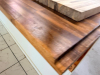 20' CUSTOM SOLID WOOD BUTCHER BLOCK COUNTERTOP SYSTEM WITH MULTIPLE CONNECTED SECTIONS, ROUNDED END SECTIONS, AND WALL-MOUNTED WOOD SUPPORT BRACKETS. COUNTERTOP FEATURES LAMINATED SOLID WOOD CONSTRUCTION WITH STAINED AND SEALED FINISH. INCLUDES MATCHING D - 5