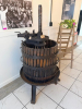 ANTIQUE WOODEN BASKET WINE / FRUIT PRESS WITH HEAVY CAST IRON FRAME, LARGE THREADED SCREW PRESS, CIRCULAR WOOD SLAT BASKET, STEEL BANDS, PRESSING PLATEN, AND CAST IRON THREE-LEG BASE. UNIT SHOWS HEAVY AGE-RELATED PATINA, SURFACE RUST, WOOD WEATHERING, AND - 4