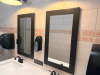 COMMERCIAL RESTROOM FIXTURE PACKAGE INCLUDING DOUBLE-SINK VANITY WITH WHITE SOLID SURFACE TOP, TWO UNDERMOUNT SINK BASINS, TWO BLACK FAUCETS, TWO FRAMED WALL MIRRORS, TWO BLACK WALL-MOUNTED LIGHT FIXTURES, TWO TOILETS, TOILET PARTITIONS, PAPER TOWEL DISPE - 4