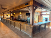 60'X 14' " U " SHAPED CUSTOM-BUILT U-SHAPED COMMERCIAL BAR WITH RUSTIC WOOD CONSTRUCTION, RAISED BAR TOP, LOWER WORK COUNTERS, EXTENSIVE BASE CABINETRY, DRAWERS, STORAGE COMPARTMENTS, DECORATIVE WOOD PANELS, HEAVY TIMBER POSTS, OVERHEAD WOOD BEAM/CANOPY S