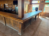 60'X 14' " U " SHAPED CUSTOM-BUILT U-SHAPED COMMERCIAL BAR WITH RUSTIC WOOD CONSTRUCTION, RAISED BAR TOP, LOWER WORK COUNTERS, EXTENSIVE BASE CABINETRY, DRAWERS, STORAGE COMPARTMENTS, DECORATIVE WOOD PANELS, HEAVY TIMBER POSTS, OVERHEAD WOOD BEAM/CANOPY S - 2