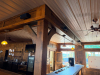 60'X 14' " U " SHAPED CUSTOM-BUILT U-SHAPED COMMERCIAL BAR WITH RUSTIC WOOD CONSTRUCTION, RAISED BAR TOP, LOWER WORK COUNTERS, EXTENSIVE BASE CABINETRY, DRAWERS, STORAGE COMPARTMENTS, DECORATIVE WOOD PANELS, HEAVY TIMBER POSTS, OVERHEAD WOOD BEAM/CANOPY S - 3