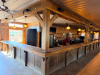 60'X 14' " U " SHAPED CUSTOM-BUILT U-SHAPED COMMERCIAL BAR WITH RUSTIC WOOD CONSTRUCTION, RAISED BAR TOP, LOWER WORK COUNTERS, EXTENSIVE BASE CABINETRY, DRAWERS, STORAGE COMPARTMENTS, DECORATIVE WOOD PANELS, HEAVY TIMBER POSTS, OVERHEAD WOOD BEAM/CANOPY S - 7