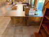 16' X 8'4" CUSTOM-BUILT COMMERCIAL SERVICE COUNTER WITH SOLID WOOD CABINETRY, RAISED PANEL DOORS, MULTIPLE DRAWERS, OPEN STORAGE SECTIONS, DECORATIVE TRIM, HEAVY WOOD BASE AND DARK TEXTURED COUNTERTOP WITH WOOD EDGE TRIM. COUNTER IS CONFIGURED IN A LARGE - 4