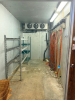 8' X 14' WALK-IN COOLER WITH INSULATED METAL PANEL CONSTRUCTION, HEAVY WOOD-FACED INSULATED ENTRY DOOR, CEILING-MOUNTED THREE-FAN EVAPORATOR, REFRIGERATION PIPING AND REMOTE OUTDOOR CONDENSING UNIT. INTERIOR INCLUDES WALL-MOUNTED BEVERAGE/DISPENSING LINES - 2
