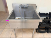 STAINLESS STEEL TWO-COMPARTMENT SINK WITH DEEP BASINS, INTEGRAL BACKSPLASH, DECK-MOUNTED FAUCET ASSEMBLY WITH FLEXIBLE SPRAY HOSE, DRAIN FITTINGS, AND FOUR STAINLESS STEEL LEGS.