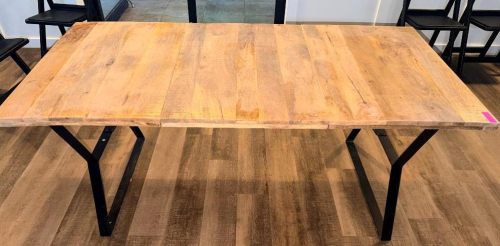 72" X 36" SOLID WOOD DINING / COMMUNITY TABLE WITH WIDE PLANK TOP AND BLACK METAL TRESTLE-STYLE LEGS. NATURAL WOOD TOP FEATURES VISIBLE GRAIN, KNOTS, COLOR VARIATION, AND A LIGHTLY DISTRESSED/RUSTIC FINISH.