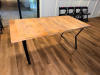 72" X 36" SOLID WOOD DINING / COMMUNITY TABLE WITH WIDE PLANK TOP AND BLACK METAL TRESTLE-STYLE LEGS. NATURAL WOOD TOP FEATURES VISIBLE GRAIN, KNOTS, COLOR VARIATION, AND A LIGHTLY DISTRESSED/RUSTIC FINISH. - 2