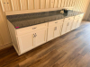 130" SPECKLED GRANITE COUNTERTOP AND MATCHING GRANITE BACKSPLASH. WHITE SHAKER-STYLE CABINETRY INCLUDES MULTIPLE DRAWERS, DOUBLE-DOOR STORAGE COMPARTMENTS, ADJUSTABLE/REMOVABLE INTERIOR SHELVING, AND DARK METAL PULL HARDWARE