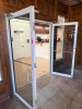 PAIR OF COMMERCIAL FULL-VIEW ALUMINUM-FRAMED GLASS ENTRY DOORS WITH CLEAR TEMPERED GLASS PANELS, PULL HANDLES, HORIZONTAL PUSH BARS, OVERHEAD HYDRAULIC DOOR CLOSERS, HINGE HARDWARE, AND ASSOCIATED FRAME COMPONENTS. WHITE FINISH.