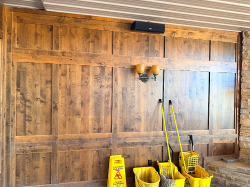 LOT OF WOOD WALL PANELING AND TRIM LOCATED THROUGHOUT THE BAR AREA, CONSISTING OF STAINED WOOD VERTICAL PANELS, RAISED FRAME AND PANEL SECTIONS, HORIZONTAL AND VERTICAL TRIM, WINDOW SURROUNDS, CORNER TRIM, AND ASSOCIATED WOOD COMPONENTS AS SHOWN. PANELING