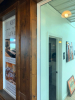 LOT OF WOOD WALL PANELING AND TRIM LOCATED THROUGHOUT THE BAR AREA, CONSISTING OF STAINED WOOD VERTICAL PANELS, RAISED FRAME AND PANEL SECTIONS, HORIZONTAL AND VERTICAL TRIM, WINDOW SURROUNDS, CORNER TRIM, AND ASSOCIATED WOOD COMPONENTS AS SHOWN. PANELING - 2