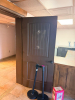 (1) SET OF HOLLOW CORE INTERIOR WOOD DOUBLE DOORS WITH DARK BROWN FINISH, DECORATIVE ARCHED UPPER PANEL, LOWER RAISED PANEL, VERTICAL GROOVE DETAILING, AND BLACK ROUND DOOR KNOB - 2