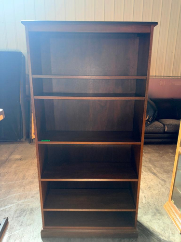 TALL OPEN BOOKCASE WITH DARK CHERRY WOOD FINISH, FIVE OPEN SHELF LEVELS, FULL BACK PANEL, DECORATIVE TOP TRIM, AND MOLDED BASE.