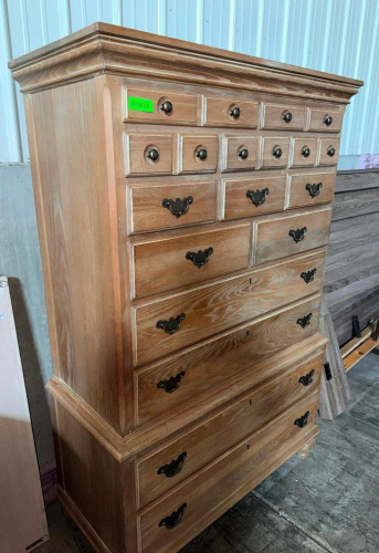 TALL TRADITIONAL-STYLE WOOD LINGERIE CHEST / HIGHBOY WITH MULTIPLE SMALL UPPER DRAWERS AND FULL-WIDTH LOWER DRAWERS. FEATURES MOLDED CROWN AND BASE TRIM, WOOD-GRAIN FINISH, AND DARK METAL KNOB AND BAIL-PULL HARDWARE.