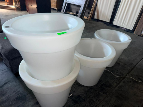 (4) ILLUMINATED PLANTERS WITH WHITE TRANSLUCENT CONSTRUCTION, ROUND TAPERED BODIES, WIDE ROUNDED RIMS, AND INTEGRATED INTERNAL LIGHTING. POWER CORDS ARE ATTACHED AS SHOWN.