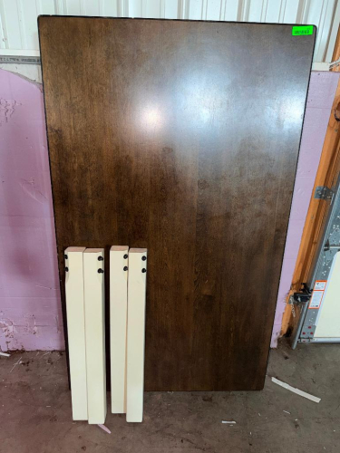 60" X 30" RECTANGULAR WOOD DINING TABLE WITH DARK BROWN FINISHED TOP AND (4) CONTRASTING CREAM / WHITE FINISHED LEGS. TABLE IS SHOWN DISASSEMBLED WITH LEGS REMOVED.