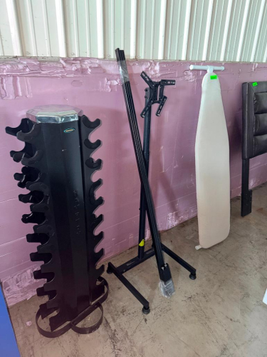 LOT OF ASSORTED HOUSEHOLD ITEMS INCLUDING VERTICAL DUMBBELL / WEIGHT STORAGE RACK, FREESTANDING TELEVISION MOUNT STAND WITH ADJUSTABLE MOUNTING BRACKET, METAL BED FRAME COMPONENTS, AND FULL-SIZE IRONING BOARD.