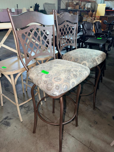 (2) MATCHING COUNTER HEIGHT BAR STOOLS WITH BRONZE-TONE METAL FRAMES, DECORATIVE LATTICE-BACK DESIGN, PADDED UPHOLSTERED SEATS, AND CIRCULAR FOOTRESTS. UPHOLSTERY FEATURES A NEUTRAL MULTI-TONE CIRCULAR PATTERN.