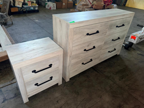 ASHLEY FURNITURE SIX-DRAWER DRESSER WITH LIGHT WOOD-GRAIN FINISH, RECTANGULAR TOP, SIX STORAGE DRAWERS, AND BLACK METAL PULL HANDLES.