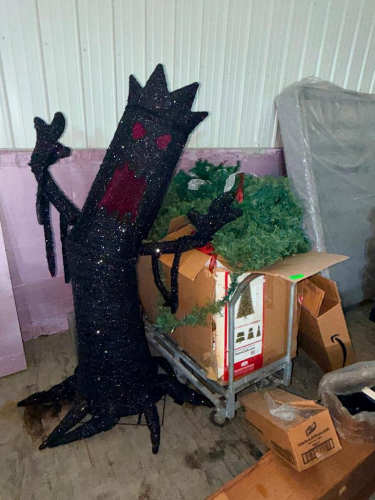 LARGE ASSORTED LOT OF HOLIDAY AND SEASONAL DECORATIONS INCLUDING OVERSIZED BLACK GLITTER HALLOWEEN TREE CHARACTER, ARTIFICIAL CHRISTMAS GREENERY, WREATHS, GARLAND, BOXED DECORATIONS, AND MISCELLANEOUS SEASONAL ITEMS.