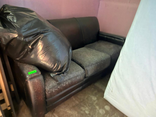 DARK BROWN THREE-SEAT SOFA WITH PADDED BACKREST, WIDE PADDED ARMS, THREE REMOVABLE SEAT CUSHIONS, AND SHORT WOOD FEET. UPHOLSTERY SHOWS MOLD AND DIRT. NEEDS CLEANED.