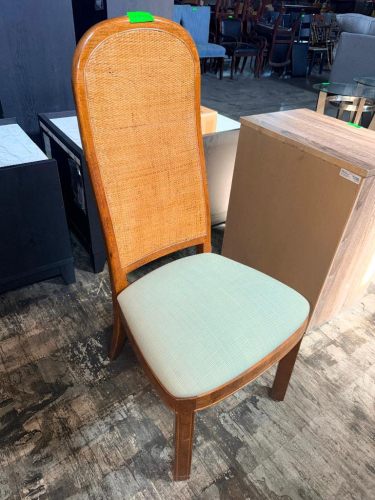 WOOD DINING SIDE CHAIR WITH TALL ARCHED BACK, WOVEN CANE BACK PANEL, PADDED UPHOLSTERED SEAT, AND FOUR-LEG WOOD FRAME.