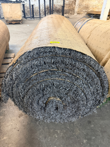 7.5' W X 40' L ARTIFICIAL TURF / ASTROTURF WITH GRAY SYNTHETIC GRASS SURFACE AND WOVEN BACKING. TURF IS ROLLED FOR STORAGE AND SHOWS VISIBLE DIRT, WEAR, FRAYING, AND RESIDUE CONSISTENT WITH PREVIOUS INSTALLATION AND REMOVAL.