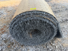 7.5' W X 40' L ARTIFICIAL TURF / ASTROTURF WITH GRAY SYNTHETIC GRASS SURFACE AND WOVEN BACKING. TURF IS ROLLED FOR STORAGE AND SHOWS VISIBLE DIRT, WEAR, FRAYING, AND RESIDUE CONSISTENT WITH PREVIOUS INSTALLATION AND REMOVAL.