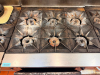 VULCAN COMMERCIAL SIX-BURNER NATURAL GAS RANGE WITH STANDARD OVEN BASE, HEAVY-DUTY CAST IRON OPEN-TOP GRATES, INDIVIDUAL BURNER CONTROLS, STAINLESS STEEL FRONT, BACKSPLASH, OVEN RACK, AND CASTERS. - 5