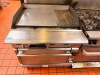 VULCAN COMMERCIAL NATURAL GAS GRIDDLE WITH STANDARD OVEN BASE, HEAVY-DUTY STEEL COOKING SURFACE WITH INTEGRATED RIBBED CHAR-GRILL SECTION, THREE FRONT BURNER CONTROLS, STAINLESS STEEL EXTERIOR, BACKSPLASH, AND CASTERS. - 2