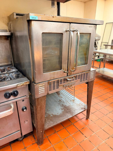 BAKERS PRIDE COMMERCIAL DOUBLE-DOOR CONVECTION OVEN WITH STAINLESS STEEL EXTERIOR, DUAL GLASS VIEWING WINDOWS, MANUAL CONTROLS, INTERIOR RACK GUIDES, AND (5) WIRE OVEN RACKS.