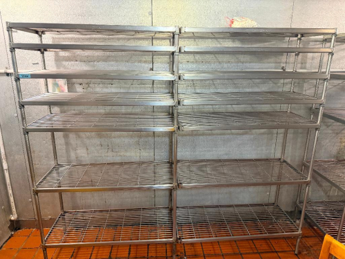 (2) 48" W X 24" D WIRE SHELVING UNITS WITH SHARED CENTER SUPPORT POLES. EACH UNIT INCLUDES MULTIPLE ADJUSTABLE OPEN-WIRE SHELVES WITH METAL UPRIGHT POSTS AND COLLAR-STYLE SHELF CONNECTIONS