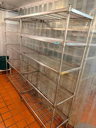 (2) 42" X 18" SECTIONS OF HEAVY-DUTY WIRE SHELVING SYSTEM CONSISTING OF MULTIPLE CONNECTED SHELVING SECTIONS WITH SHARED VERTICAL POSTS BETWEEN ADJOINING SECTIONS. OPEN WIRE SHELVES WITH ADJUSTABLE SPLIT-SLEEVE POST COLLARS