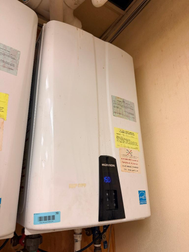 COMMERCIAL WALL-MOUNTED CONDENSING TANKLESS WATER HEATER WITH DIGITAL TEMPERATURE DISPLAY, FRONT-MOUNTED CONTROLS AND ENERGY STAR RATING